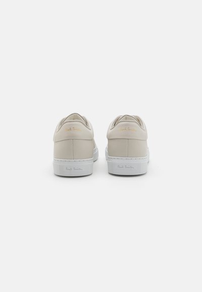 Light beige leather sneakers with white rubber soles. Features a textured back panel and gold embossed "Paul Smith" branding on the heel.