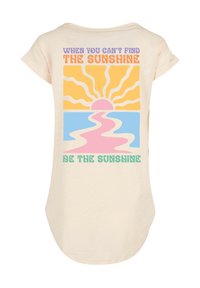 Light beige short-sleeve shirt featuring a colorful graphic with a sun and ocean, text above and below in various pastel colors and playful fonts.
