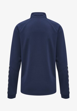 Marineblå pullover-jakke med struktureret overflade, høj krave og kontrasterende mønstrede detaljer langs ærmerne. Regular fit, lange ærmer.