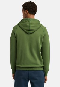 Grüne Kapuzenjacke aus weichem Stoff mit Kordelzug und gerippten Bündchen. Verfügt über sichtbare Nähte und hat ein lässiges Design.