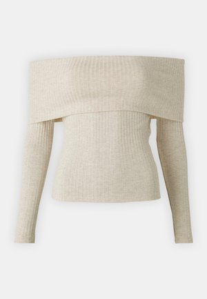 Top bez ramínek ve světle béžovém žebrovaném pleteném materiálu, s dlouhými rukávy a hladkou texturou. Jednoduchý a moderní design.