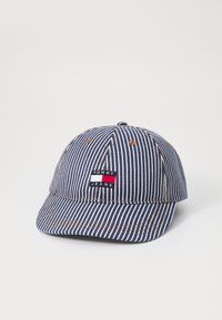 Stripet navy cap med en buet skygge, der har et broderet "TOMMY JEANS" logo og brune stikninger. Fremstillet af tekstureret bomuldsblanding.
