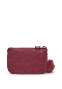 Pochette per monete in tessuto bordeaux con zip, bordi arrotondati e un pompon soffice attaccato alla zip. Texture liscia.
