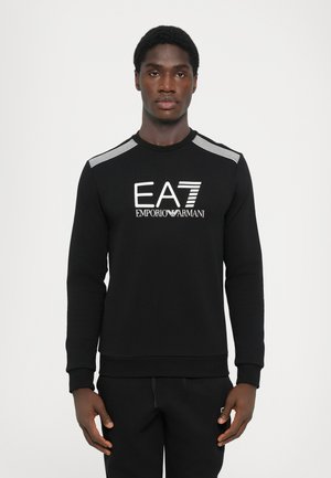 Black sweatshirt with long sleeves, ribbed collar, and cuffs. Features a white EA7 Emporio Armani logo on the front and stripe accents on the shoulders.