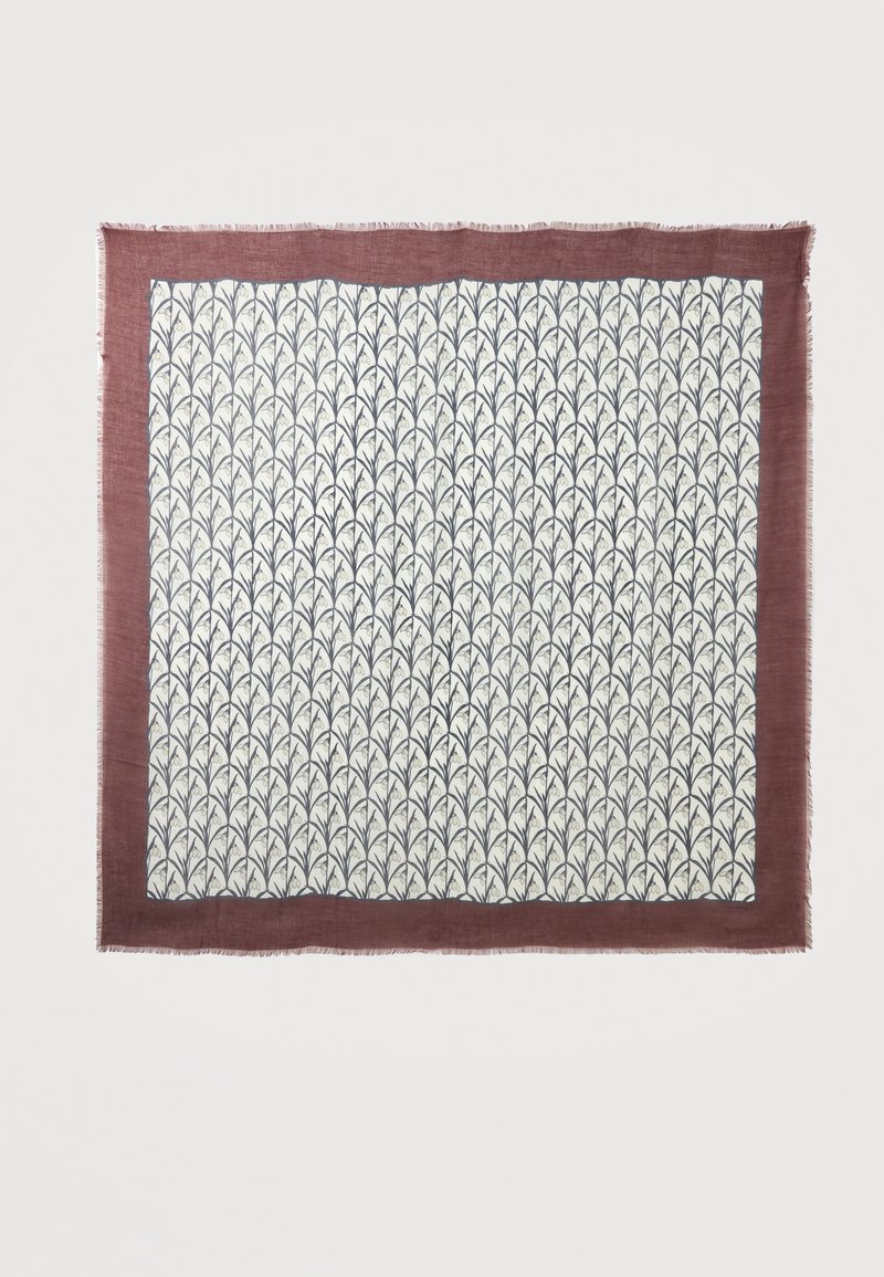 Tissu carré blanc avec motif répétitif de feuilles noires et large bordure rouge foncé aux bords effilochés sur fond uni.