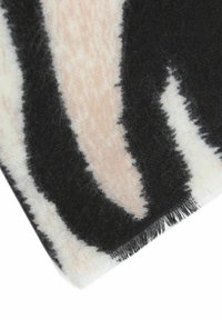 Soft wool blend scarf featuring a bold black and light pink abstract pattern, with fringed edges and a smooth texture.