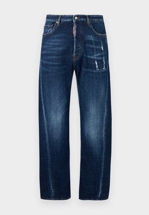 Blue straight-leg jeans with slight fading, distressed patches on right thigh, five-pocket style, and button closure with red brand tag on fly.