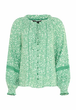 Groene blouse met lange mouwen en wit bloemenpatroon, knoopsluiting aan de voorkant, gerimpelde manchetten, kanten details op de mouwen en een strikkraag.