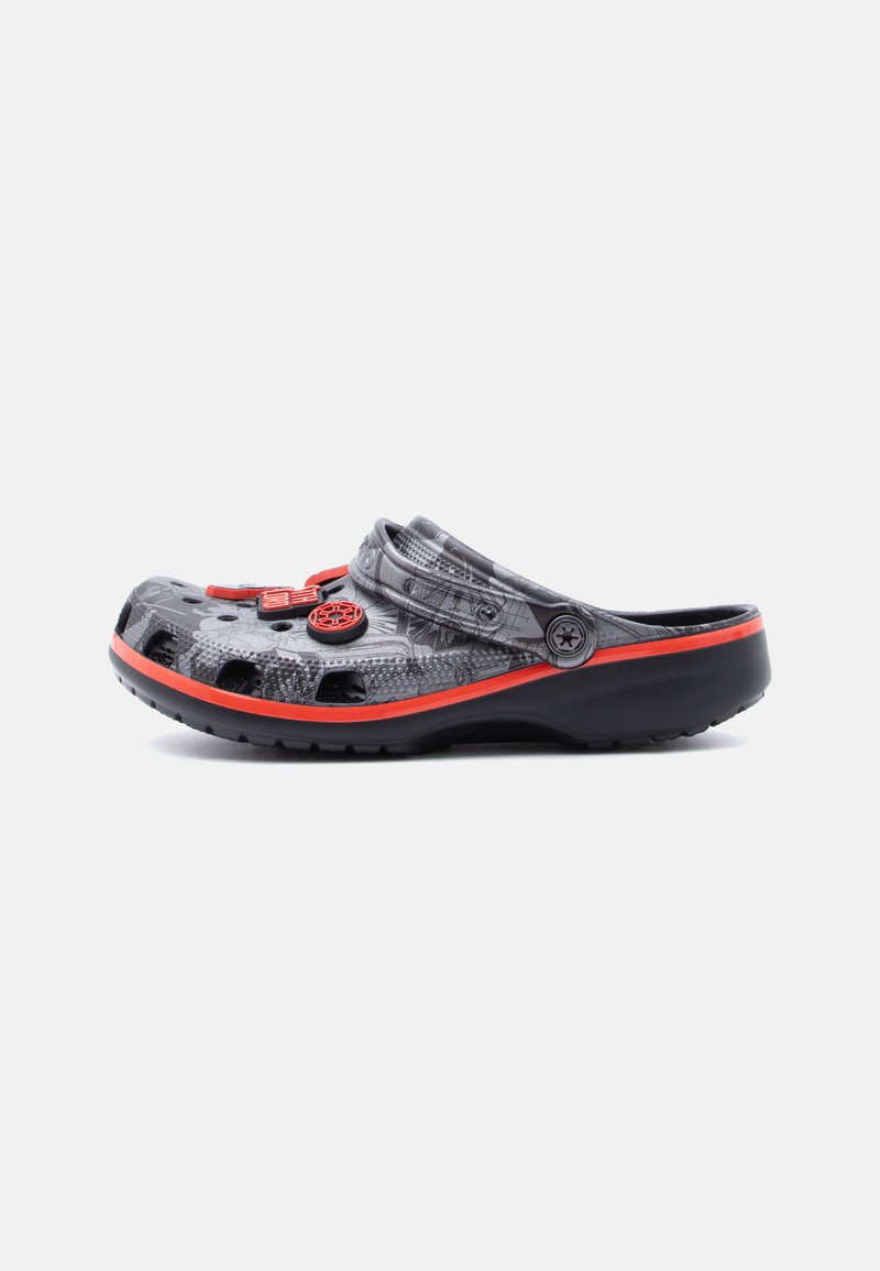 Black and gray slip-on clog with red trim and decorative circular vents on a white background.