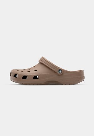 Brown clogs made from lightweight material with ventilation holes, a back strap, and a textured sole for grip. Round toe design.