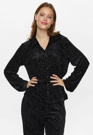 Black, textured shirt with polka dot pattern, button closure, long sleeves, and a collar. Soft fabric with a slight sheen.