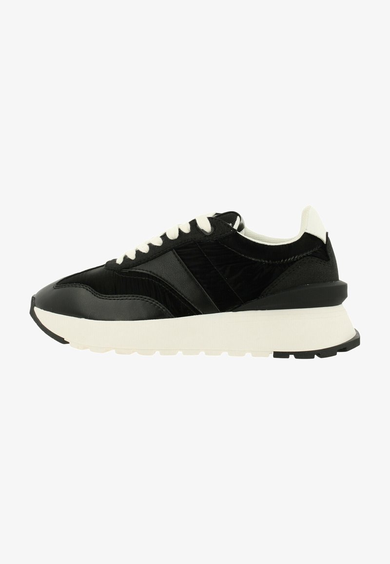 Black sneakers with leather and textured fabric upper, white laces, thick white midsole, and black rubber sole, featuring geometric design accents.