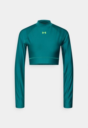 Teal cropped long-sleeve top made of smooth, stretchy fabric. Features a high neckline and contrasting neon logo on the chest.