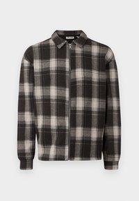 Black and white checkered flannel jacket with a zip closure, collared design, long sleeves, and soft texture.