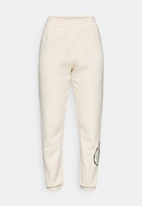 Cream-colored sweatpants made of soft fabric; feature an elastic waistband and a black embroidered floral design on the left thigh.