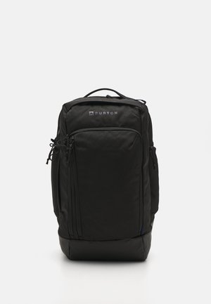 Black backpack made of durable fabric. Rectangular shape with a padded bottom, front zippered pockets, and textured surface. Logo visible.