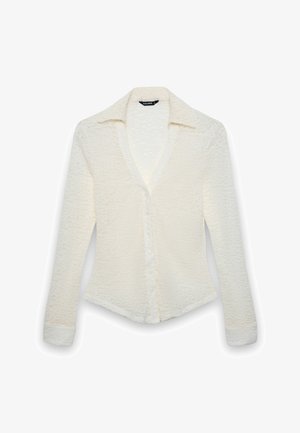 White long-sleeve shirt with a textured pattern, button front closure, and a collared neckline. Features a fitted silhouette and tapered sleeves.