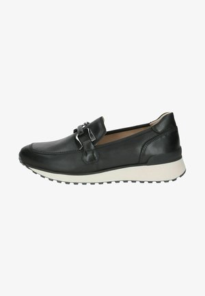 Musthave mustad nahktossud ümmarguse varbaga, dekoratiivse riistvaraga ja valge kummist välispõhjaga, millel on tekstuuriga mustrimuster.