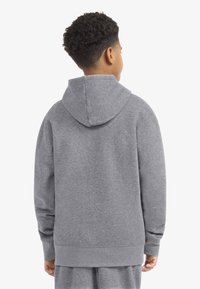 Gray sweatshirt with a hood, soft texture, ribbed cuffs and hem, features a relaxed fit with a simple design. View from the back.