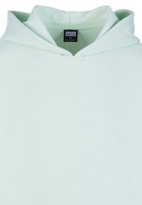Sudadera de color verde menta claro con una textura suave, presenta una capucha con cordón y una etiqueta que dice "URBAN CLASSICS M." Diseño simple y minimalista.