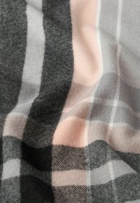 Szary i różowy szalik w kratę wykonany z miękkiego materiału, z tkaną teksturą i różnymi odcieniami szarości z jasnoróżowymi akcentami.