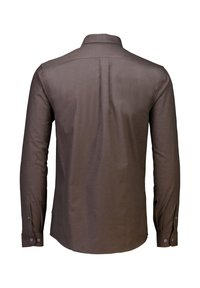 Brun långärmad skjorta i texturerat tyg med knäppta manschetter och detalj på bakre infodring. Har en mjuk krage och rundad nederkant.