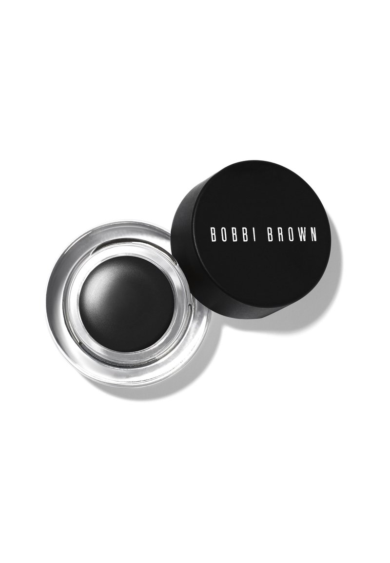 Czarny kremowy eyeliner w przezroczystym szklanym słoiczku z czarną pokrywką, na której znajduje się biała napis "BOBBI BROWN". Gładka tekstura, okrągły kształt, elegancki design.