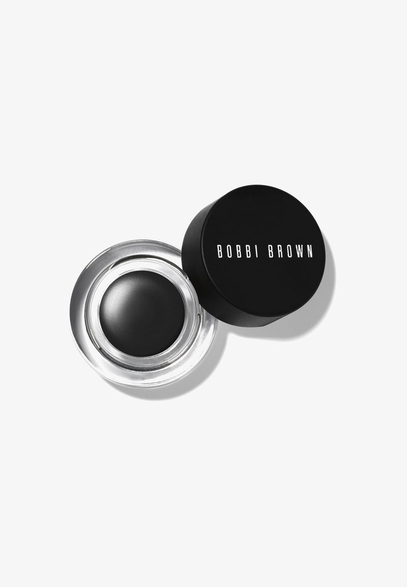 Schwarzer Creme-Eyeliner in einem klaren Glasbehälter mit einem schwarzen Deckel, auf dem in weißer Schrift "BOBBI BROWN" steht. Glatte Textur, runde Form, elegantes Design.
