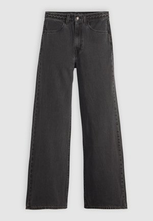 Jeans larges noirs avec une taille tressée, cinq poches et en denim de poids moyen. La couleur est uniforme avec un léger délavage.