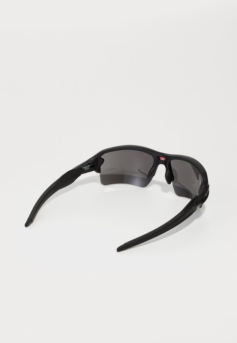 Black sunglasses with a sporty design, featuring dark lenses, a matte finish, and curved arms for a secure fit. Lightweight material construction.