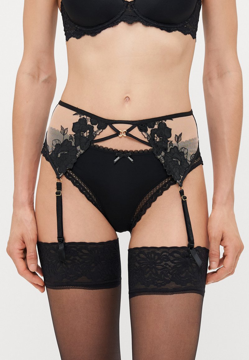 Black lingerie set featuring a high-waisted brief with floral lace accents, sheer panels, and adjustable garter straps. Textured stockings complete the look.
