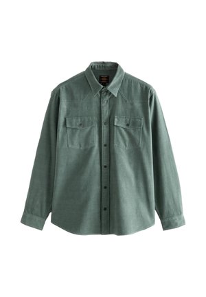 Zöld hosszú ujjú, gombos ing gallérral és két zsebfedeles mellzsebbel, puha, texturált anyagból.