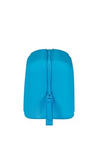 Custodia in silicone blu con chiusura a zip, caratterizzata da una superficie liscia e una parte superiore leggermente curvata, progettata per un facile accesso e stoccaggio.