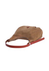 Bolso de ante color canela con forma redondeada, correa de cuero roja y cremallera plateada. Presenta un pequeño detalle de logotipo en la parte frontal.