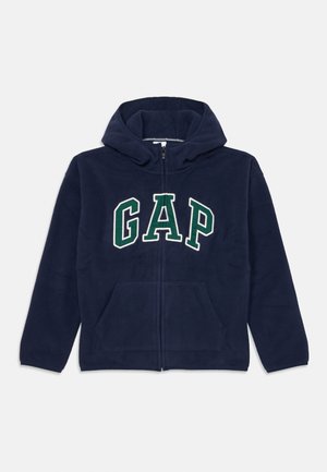 Navy blue fleece hoodie with front zip, large "GAP" logo in white and green, two front pockets, and a drawstring hood.