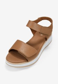 Sandalia de cuero marrón con dos correas anchas y cierres de velcro ajustables. Cuenta con una plantilla acolchada y una suela de goma blanca. Talla 36.