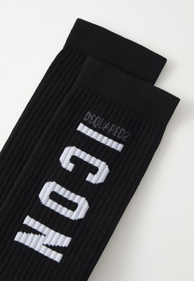 Black ribbed socks featuring bold white "ICON" text and "DSQUARED2" logo text in subtle grey on the upper section.