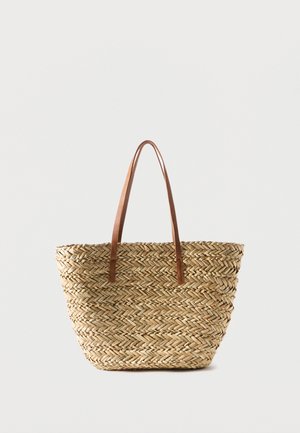 Woven straw tote bag with braided texture and two long brown leather handles, shown on plain light background.