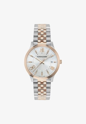 Silver and gold-tone stainless steel watch with a round silver dial, Roman numerals, date window, and a textured bracelet design.
