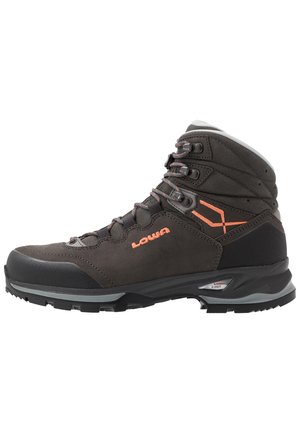 Brown leather hiking boot with orange accents, high ankle support, rubber toe cap, and textured surface. Features metal hooks for laces.