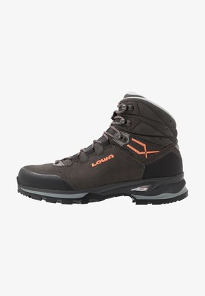 Brown leather hiking boot with orange accents, high ankle support, rubber toe cap, and textured surface. Features metal hooks for laces.