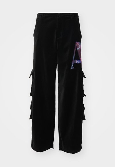 Black corduroy cargo pants featuring side pockets and a colorful 'A' graphic on the left thigh. Loose fit with textured fabric and subtle detailing.