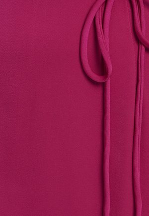 Fuchsia fabric with a smooth texture, featuring two narrow ties on the right side for closure. Minimalist design with no patterns.