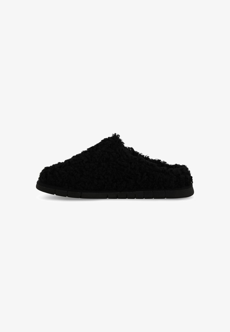 Pantofole nere con esterno soffice e testurizzato e suola liscia e flessibile. Design slip-on con forma arrotondata e stile minimalista.