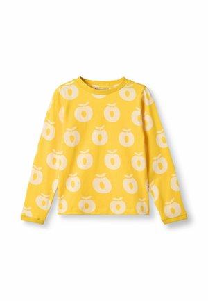 Žuta majica dugih rukava s bijelim uzorkom jabuka, napravljena od mekanog pamuka. Okrugli izrez i manžetne na rukavima. Standardni kroj i ležerni dizajn.