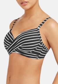 Czarny i biały bikini z paskami, z koronkowym wzorem, regulowanymi ramiączkami i gładką teksturą. Oferuje wsparcie i pokrycie boczne.