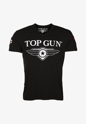 Schwarzes Baumwoll-T-Shirt mit V-Ausschnitt, auf der Vorderseite mit einem weißen "TOP GUN"-Logo und einem geflügelten Stern-Graphic sowie einem roten Patch auf dem Ärmel.