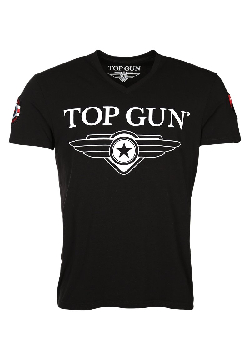 Mustan puuvillapaidan V-pääntie, jossa on valkoinen "TOP GUN" -logo ja siipitähti-graafinen kuva etupuolella sekä punainen merkki hihassa.