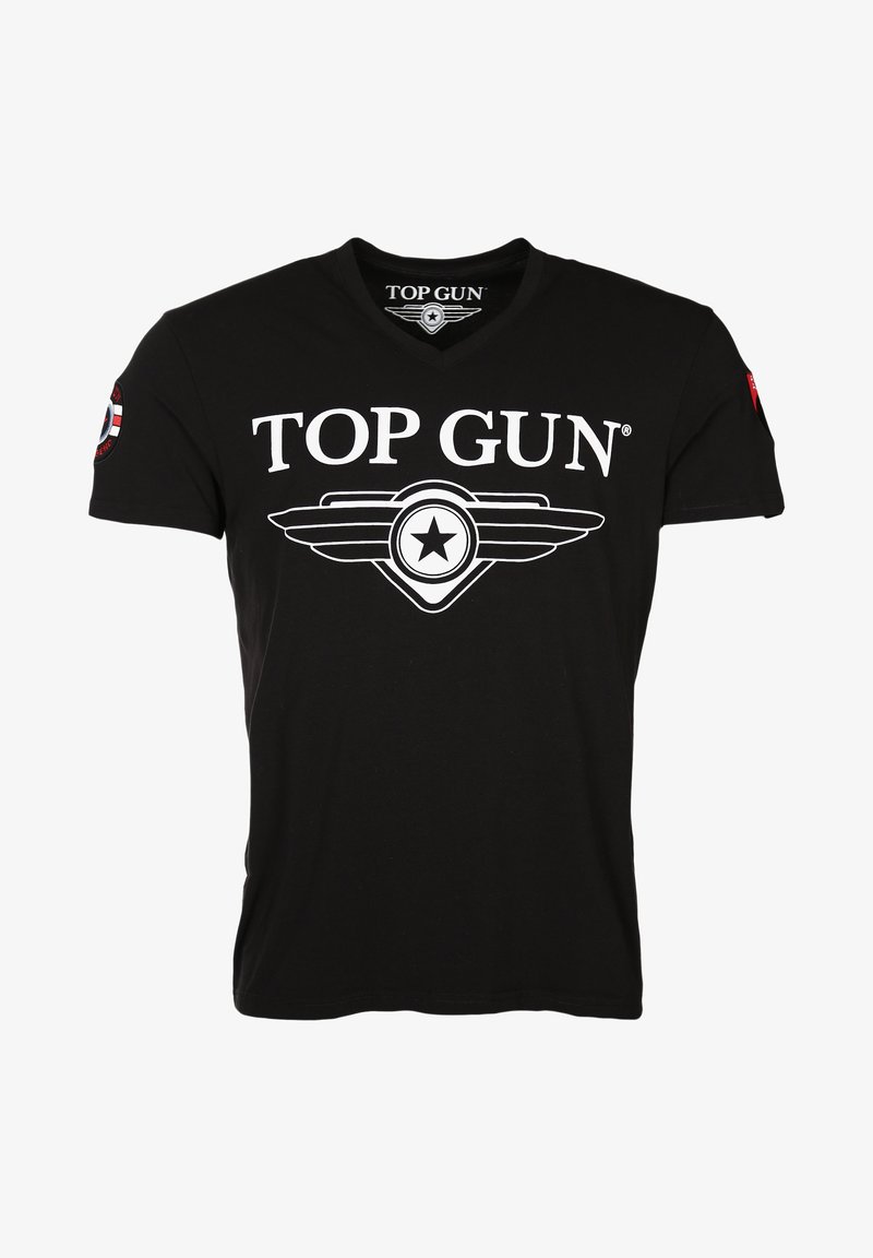 Mustan puuvillapaidan V-pääntie, jossa on valkoinen "TOP GUN" -logo ja siipitähti-graafinen kuva etupuolella sekä punainen merkki hihassa.