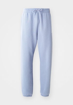 Light blue sweatpants made of soft, stretchy fabric. Features an elastic waistband with drawstring and ribbed cuffs at the ankle.